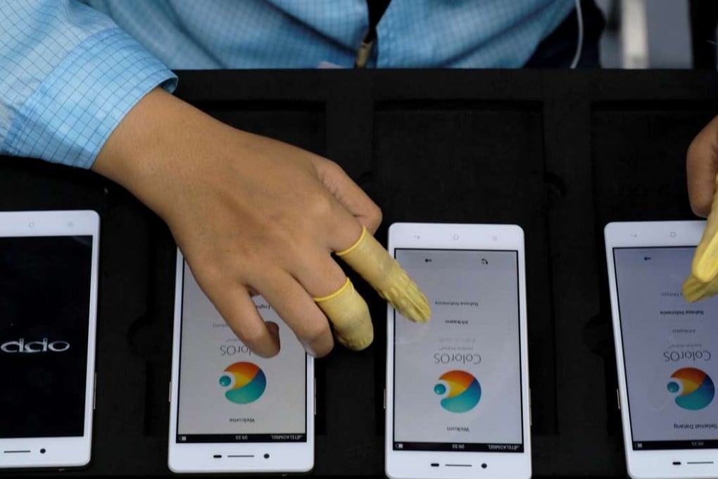 A worker tests Oppo smartphones at the company’s factory in Indonesia. Oppo said it has filed more than 50 patents for its new 5X dual camera zoom technology. Photo: Reuters