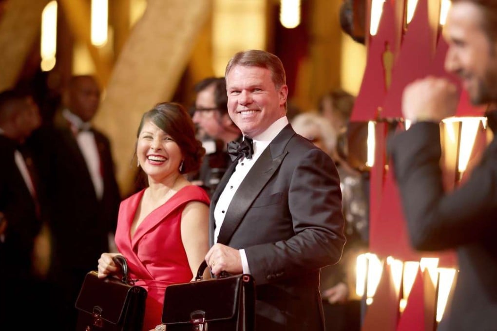 PricewaterhouseCoopers accountant Brian Cullinan, centre, with fellow accountant Martha L. Ruiz, on the red carpet of the Oscars before the show that ended with the worst foul-up in the awards’ history. Photo: AFP