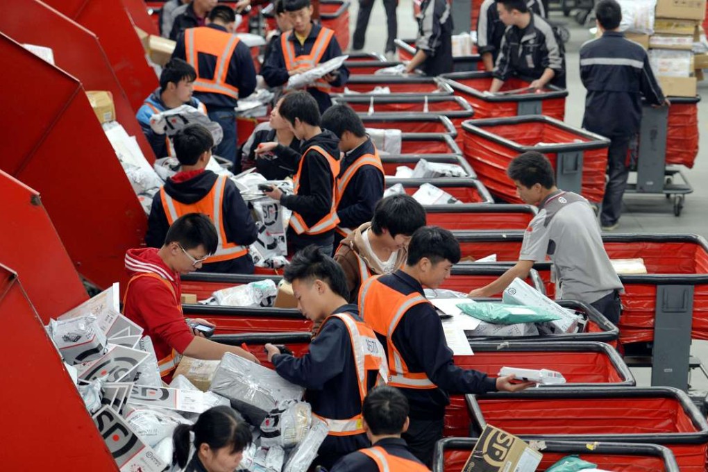Chinese workers sort parcels at an SF Express distribution centre in Wuhan, Hubei province. The company’s chairman Wang Wei vaulted to third richest person in China after its shares surged for a fourth straight day. Photo: Imaginechina