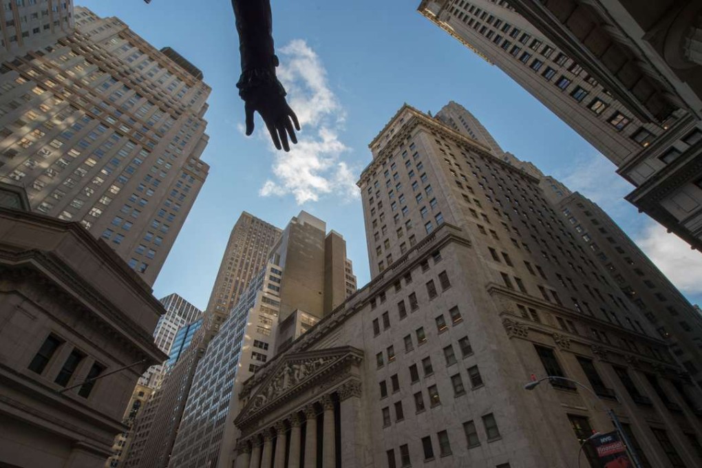 The hand from a statue of George Washington, overlooking the New York Stock Exchange, is seen in New York on February 16. US President Donald Trump is determined to give businesses a break. Yet, Commerce Department statistics show that corporate earnings remain strong. Photo: AFP
