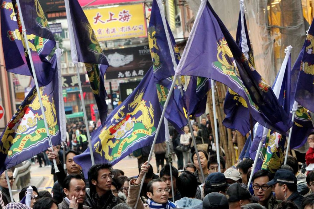Members of the Hong Kong Autonomy Movement carry a colonial flag of Hong Kong amid a protest against chief executive Leung Chun-ying in 2013. Photo: David Wong