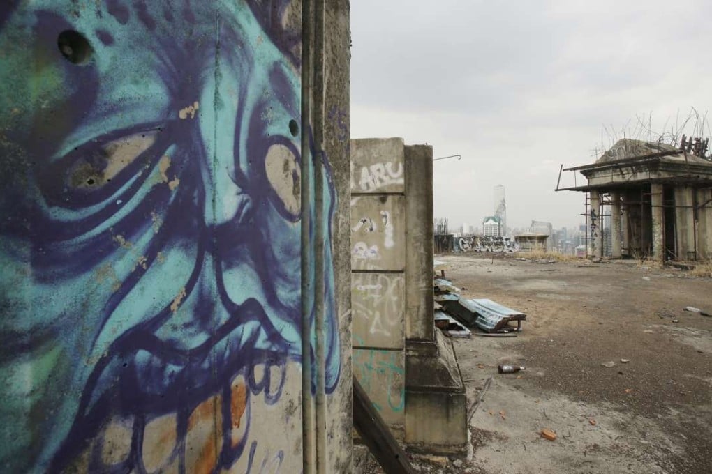 Empty beer bottles and graffiti litter the roof of the Sathorn Unique building. Photo: AP