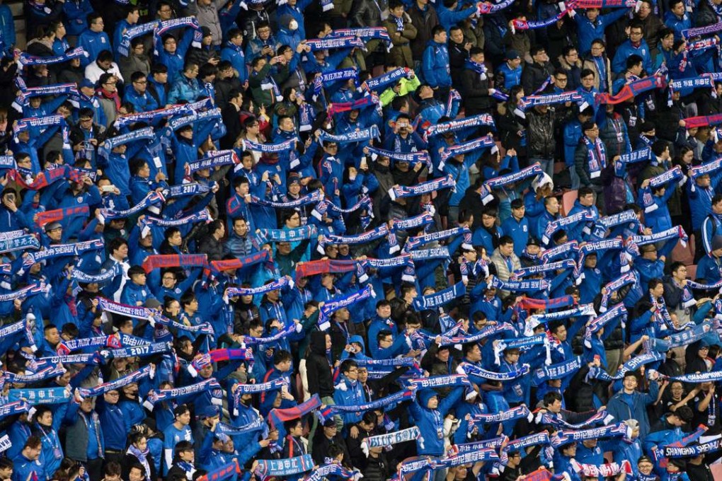 Fans of Shanghai Shenhua hold up scarves during their AFC Champions League game against Brisbane Roar. Photo: Reuters