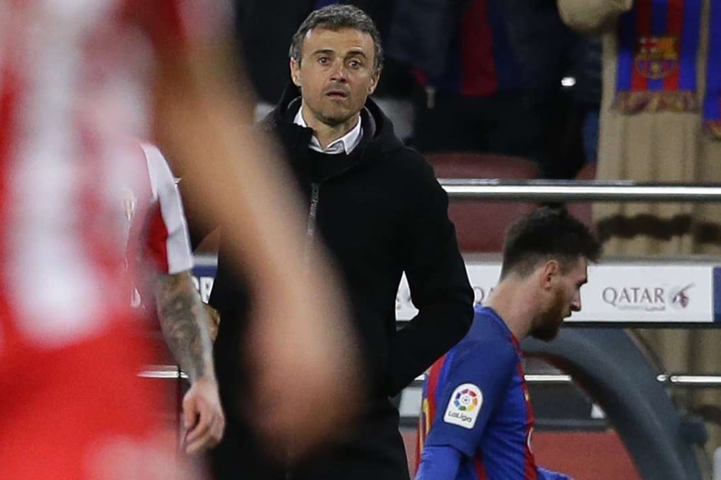 FC Barcelona's coach Luis Enrique stands next to Lionel Messi during the Spanish La Liga soccer match between FC Barcelona and Sporting Gijon at the Camp Nou stadium in Barcelona, Spain. Luis Enrique said he will not stay as Barcelona coach after this season. Photo: AP