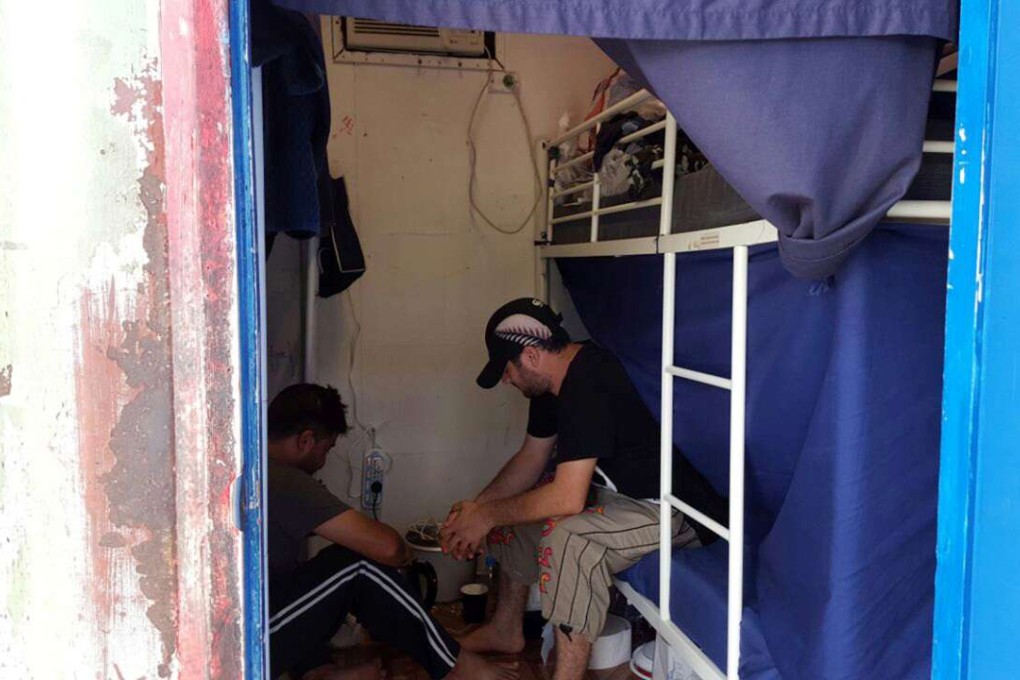Detainees sit inside accommodation at the Manus Island detention centre in Papua New Guinea. Photo: Reuters