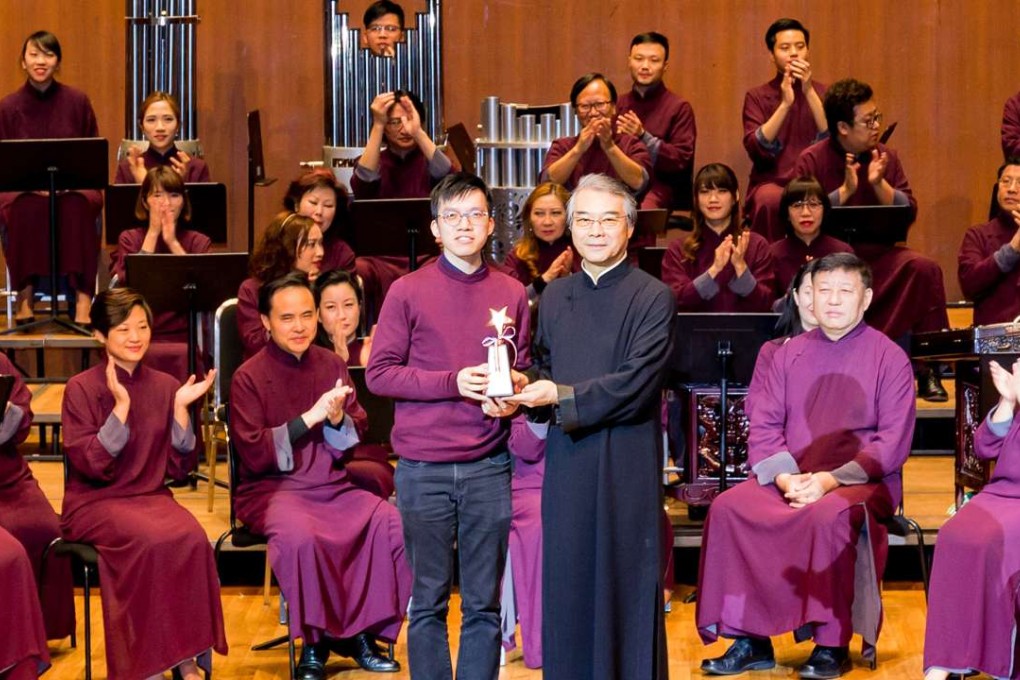 Composer Tam Yat-sing (left) picking up one of his three prizes from Yan Huichang, artistic director of the Hong Kong Chinese Orchestra. Photo: Handout