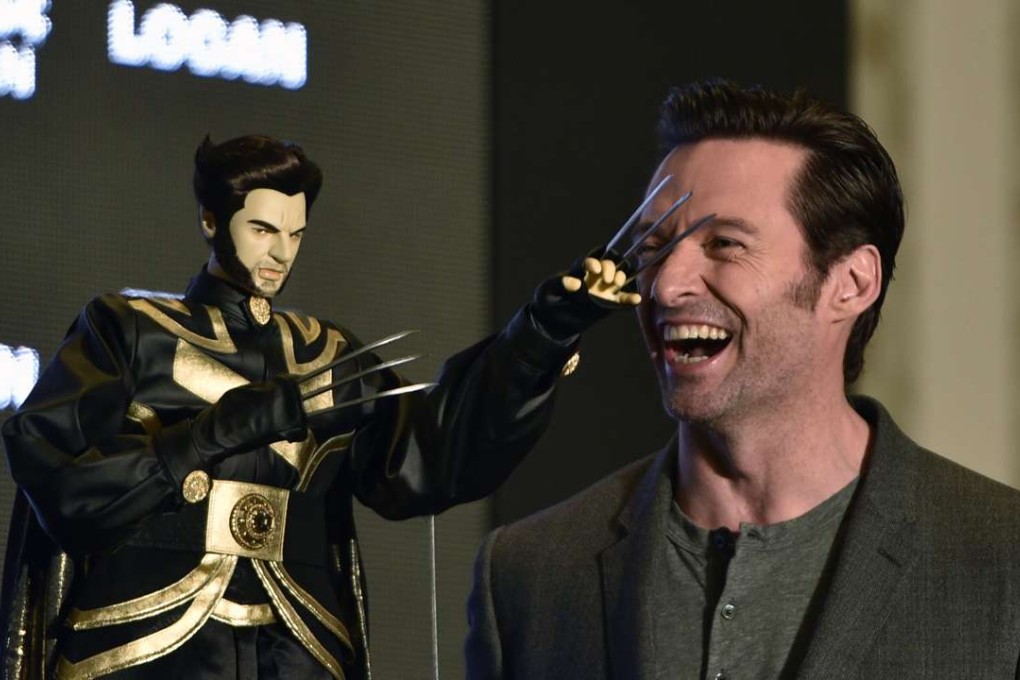 Australian actor Hugh Jackman laughs next to a Wolverine puppet gift while promoting Logan in Taipei this week. Photo; AFP