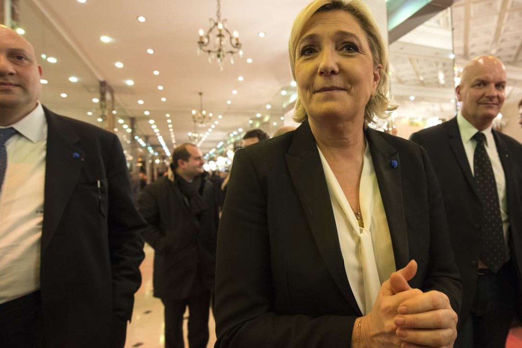The lLeader of France's far-right Front National political party and candidate for the 2017 French presidential elections, Marine Le Pen (C), arrives to hold a news conference in Paris, France. Photo: EPA