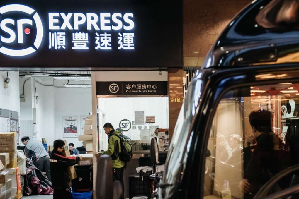 Employees handle packages at an S.F. Express store in Hong Kong. Photo: Bloomberg