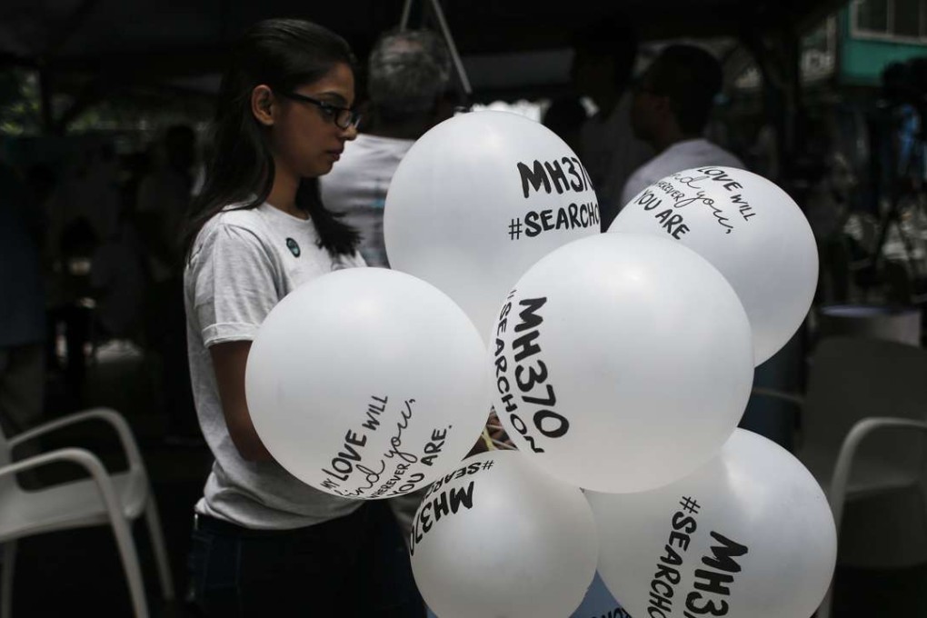 A woman at a remembrance ceremony for the missing flight. Photo: EPA