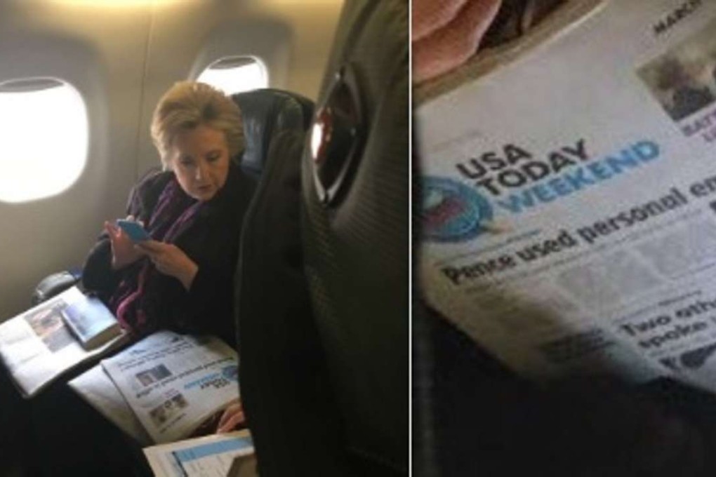 Hillary Clinton was on an airplane travelling from Boston to New York on Friday when a fellow passenger, Caitlin Quigley, snapped a photo of her glancing down at Friday’s USA Today newspaper front page headline ‘Pence used personal email in office’. Photo: Caitlin Quigley