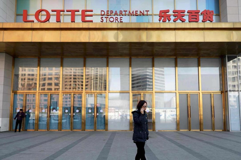 A woman walks past a department store in Shenyang owned by South Korea's huge Lotte Group. The firm’s Chinese website was attacked after it was revealed the firm will provide land for the South Korean missile shield system. Photo: AFP