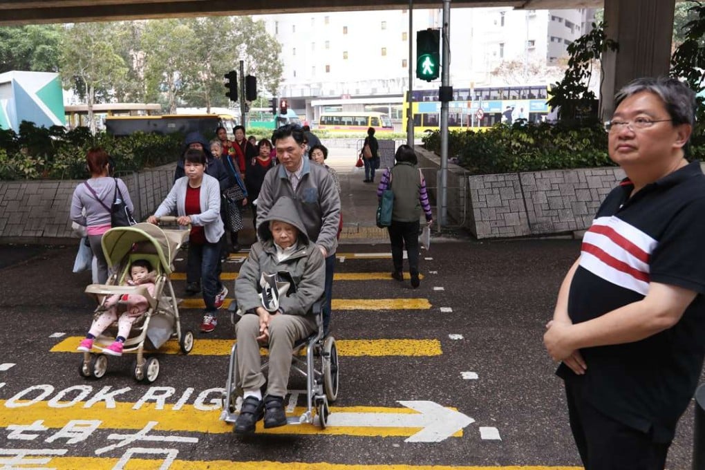 Eastern district councillor George Lam (right) won one second more time for pedestrians to cross this road. Photo: Nora Tam