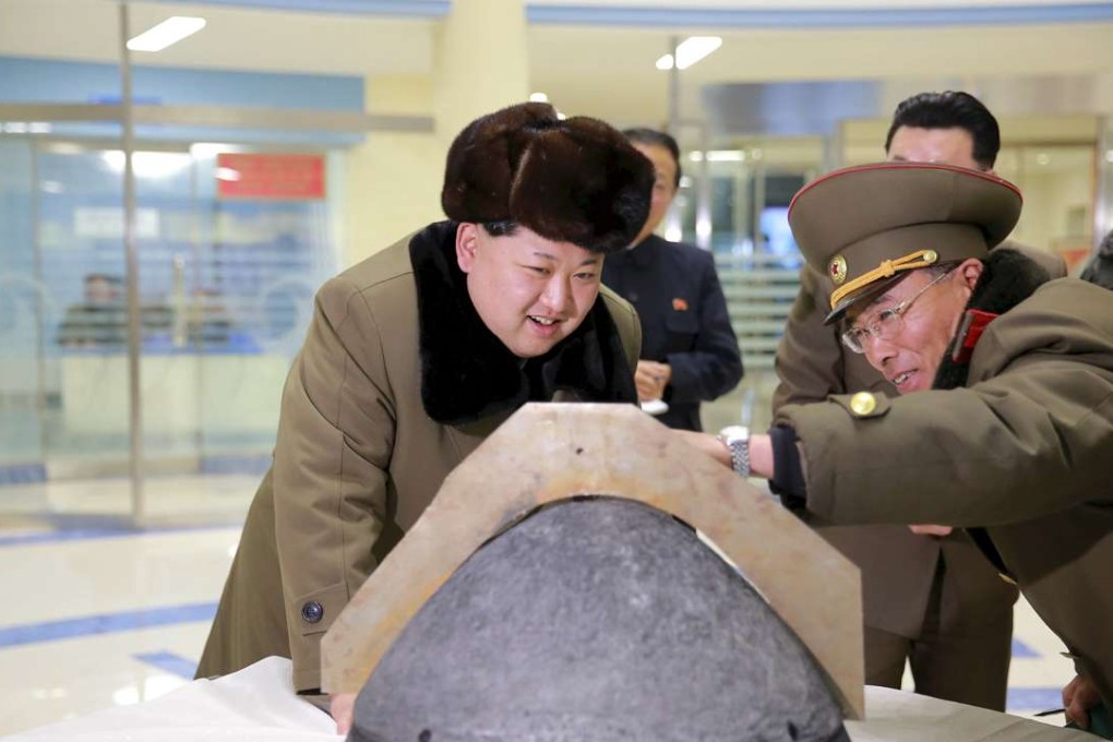 North Korean leader Kim Jong-un looks at a rocket warhead tip. Photo: Reuters