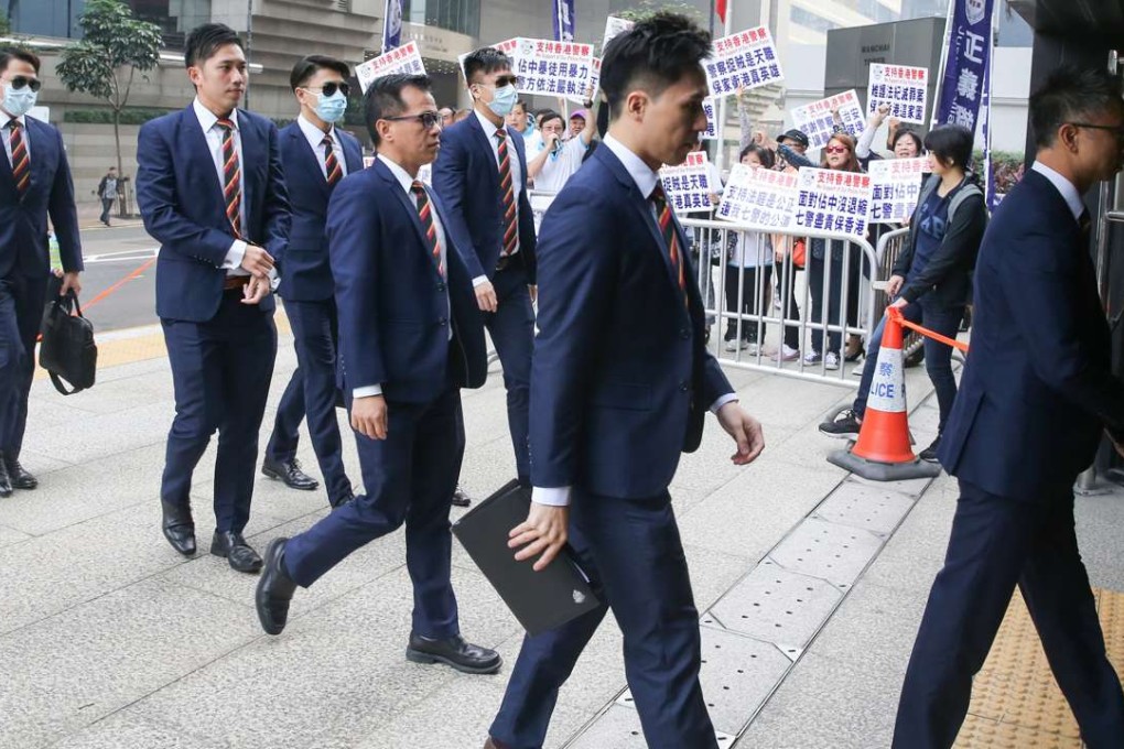 The seven police officers arrive at the District Court for their trial. Photo: Sam Tsang