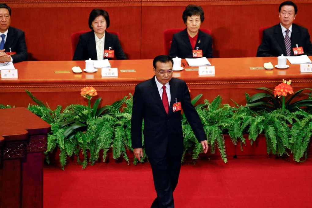 Premier Li Keqiang walks onstage to deliver a government work report during the opening session of the National People's Congress. Photo: Reuters