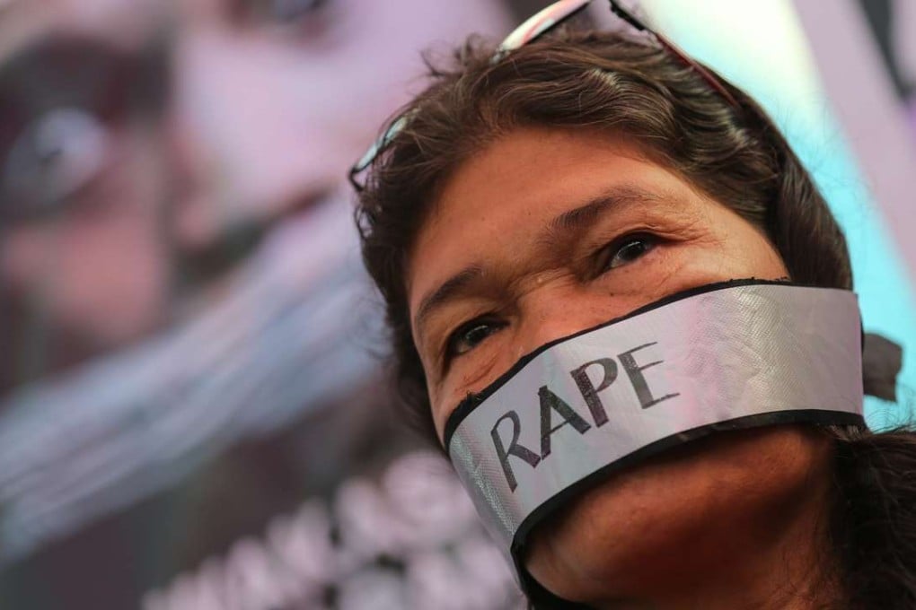A Filipino woman activist with a duct tape on her mouth takes part in protest targeting violence against women in Manila in 2015. Photo: EPA