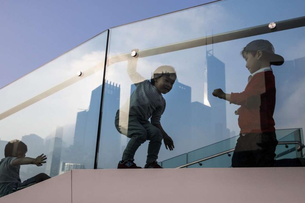 Children play on a viewing platform in Hong Kong. The debate over declining foreign language standards in Hong Kong is a tired one, but its verdict should be clear: if the city is to live up to its self-styled reputation as “Asia’s World City”, our students need to learn world languages. Photo: AFP