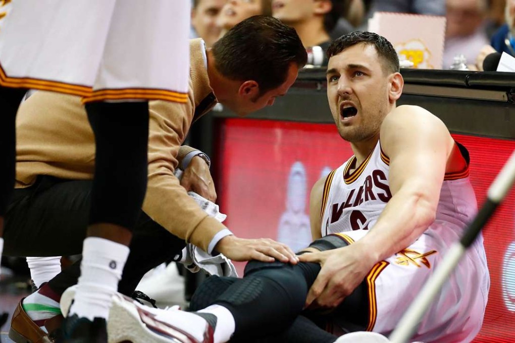 Andrew Bogut reacts after breaking his leg. Photo: AFP