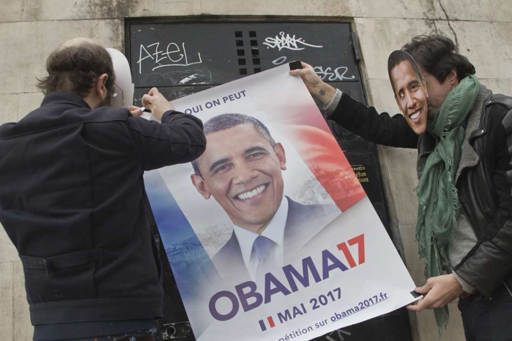 Two organiser of a online petition known under the pseudonym of Antoine and Antoine wearing masks of former US President Barack Obama as they stick a campaign poster on a wall who reads "yes we can" in Paris. An online petition urging Barack Obama to join the French presidential race has attracted more than 45,000 signatures in 10 days. Photo: AP
