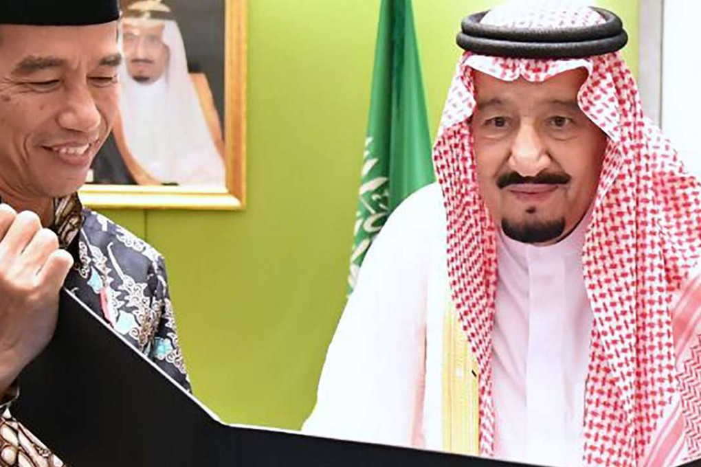 Indonesia's President Joko Widodo presents a photo album with images from their meeting in Bogor to Saudi Arabia's King Salman bin Abdul Aziz in Jakarta on Friday. The king will soon head to China but a date for the trip has not been set. Photo: AFP