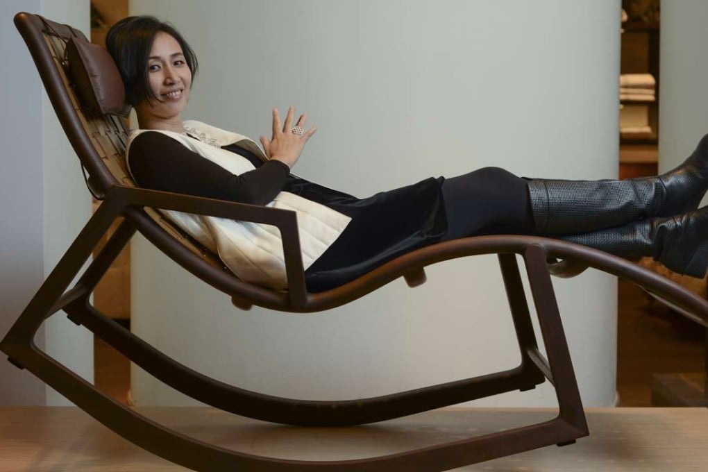 Chinese designer Jiang Qionger of brand Shang Xia poses with her Da Tian Di rocking chair at Lane Crawford Home Store in Pacific Place, Admiralty, Hong Kong. Photo: Antony Dickson