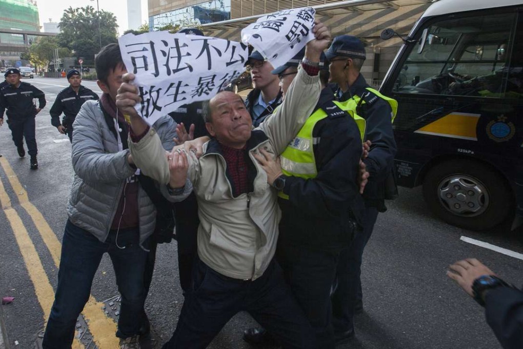 A protester objects to the conviction of the seven police officers for assaulting an Occupy protester. Photo: EPA