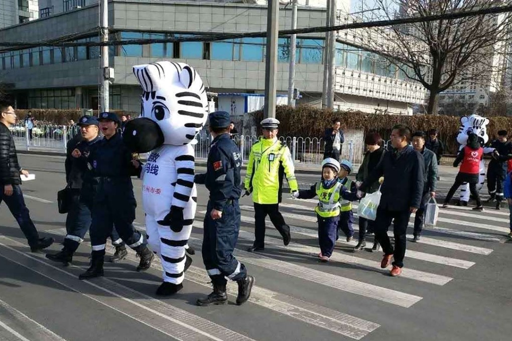 traffic inspection volunteers were last Friday sent out on the streets of Lanzhou, Gansu province, dressed in full-body zebra costumes to teach people how to use the zebra crossings in the city. Photo: Handout