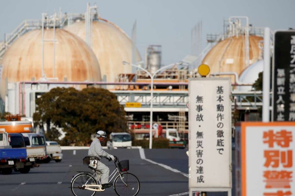 A worker riding a bicycle passes the Fuji Oil Co.'s Sodegaura Refinery in Sodegaura. Photo: Reuters