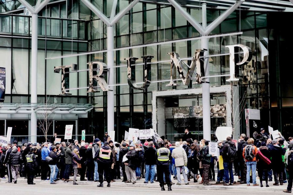 Protesters stage a rally at the entrance to the Trump International Hotel and Tower in Vancouver during opening day on February 28, 2017. Photo: AFP