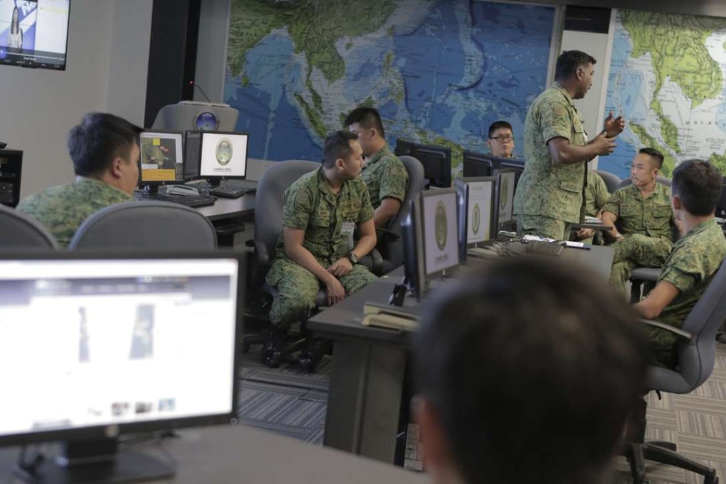 Military personnel listen to a briefing for members of the press at the Changi Regional Humanitarian Assistance and Disaster Communication Centre at Changi Naval Base in Singapore. The Singapore Ministry of Defence said a breach was detected in its I-Net system. Photo; EPA