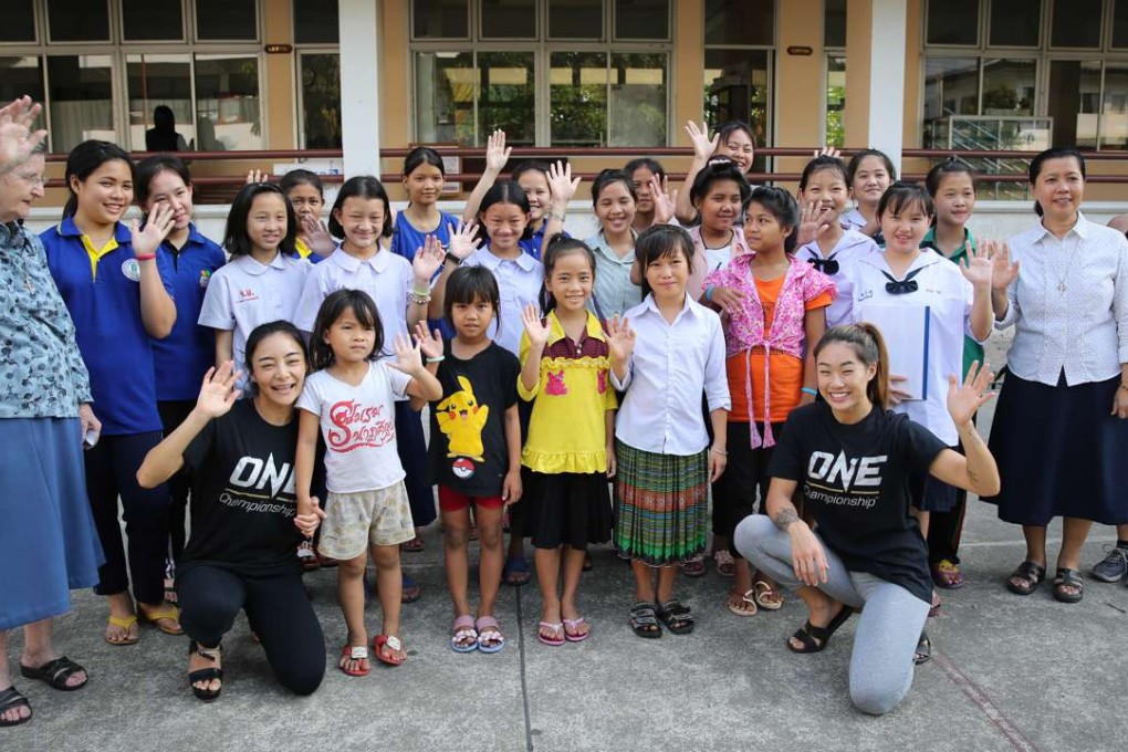 Angela Lee (right in black t-shirt) visits the Good Shepherd Sisters women’s shelter in Bangkok. Photo: Handout