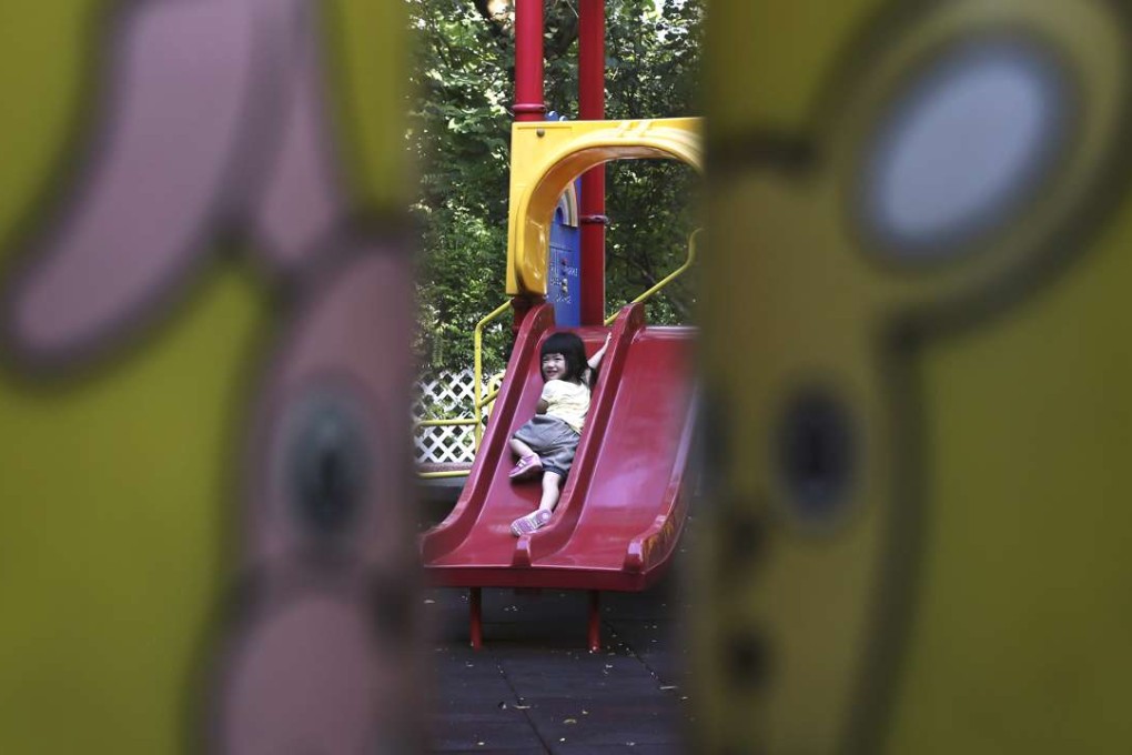 A girl has fun in a playground at Chai Wan. Our children should be allowed to enjoy their childhood. Photo: Sam Tsang