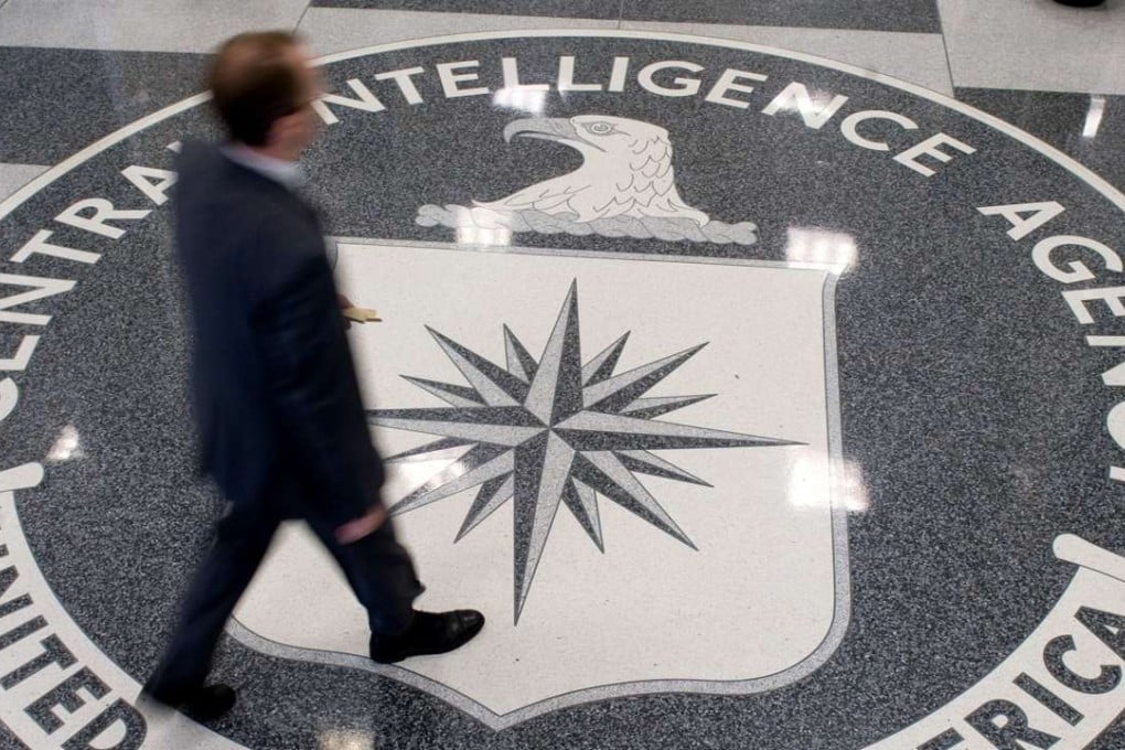 A man walks over the seal of the Central Intelligence Agency (CIA) in the lobby of CIA Headquarters in Langley, Virginia. The CIA can turn your TV into a listening device, bypass popular encryption apps, and possibly control your car, according to a trove of alleged documents from the US spy agency released by WikiLeaks. Photo: AFP
