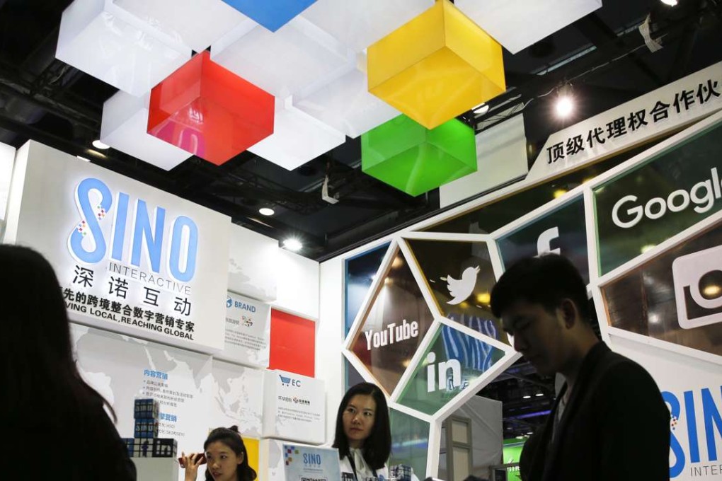 In this 2016 file photo, a visitor browses a booklet at a social network company booth which enable people to connect global clients during the 2016 Global Mobile Internet Conference (GMIC) in Beijing. Photo: AP