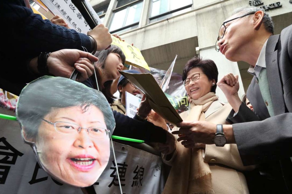 Former chief secretary Carrie Lam (centre) meets petitioners before attending the forum. Photo: Felix Wong