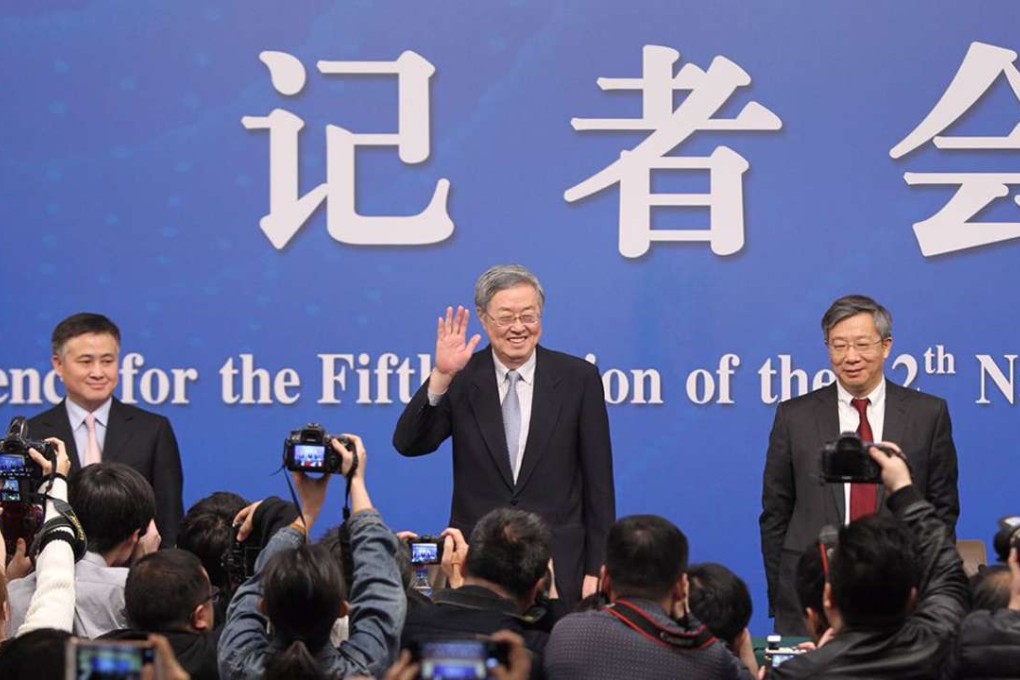 Zhou Xiaochuan (centre), governor of the People's Bank of China, speaks to the press at the media centre in Beijing on Friday morning. Photo: Simon Song