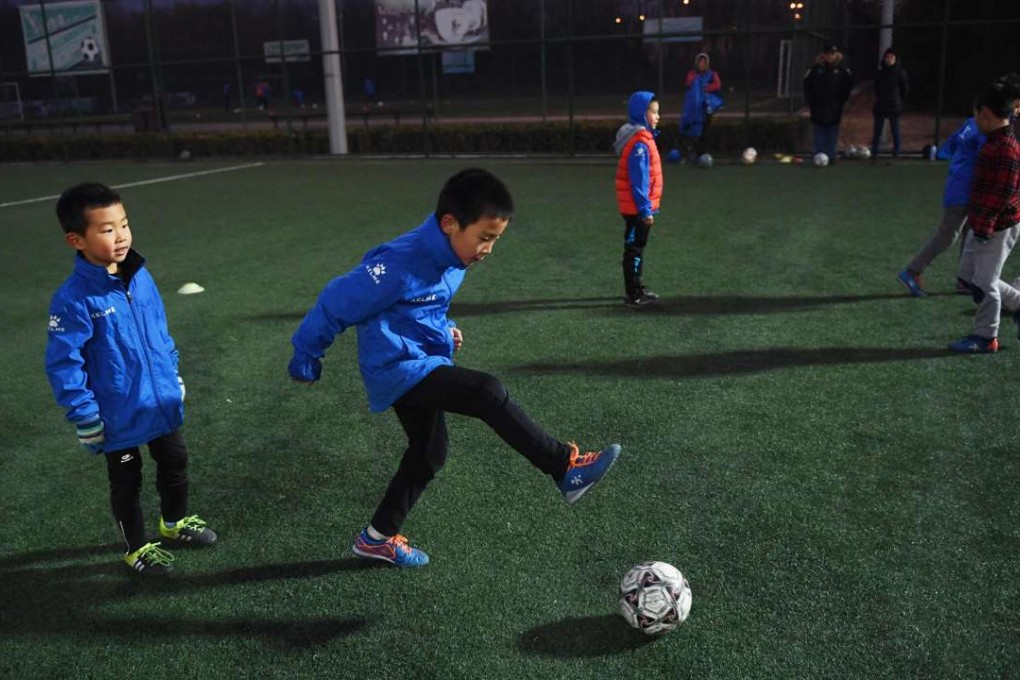 Children practise football in Beijing. Photo: AFP