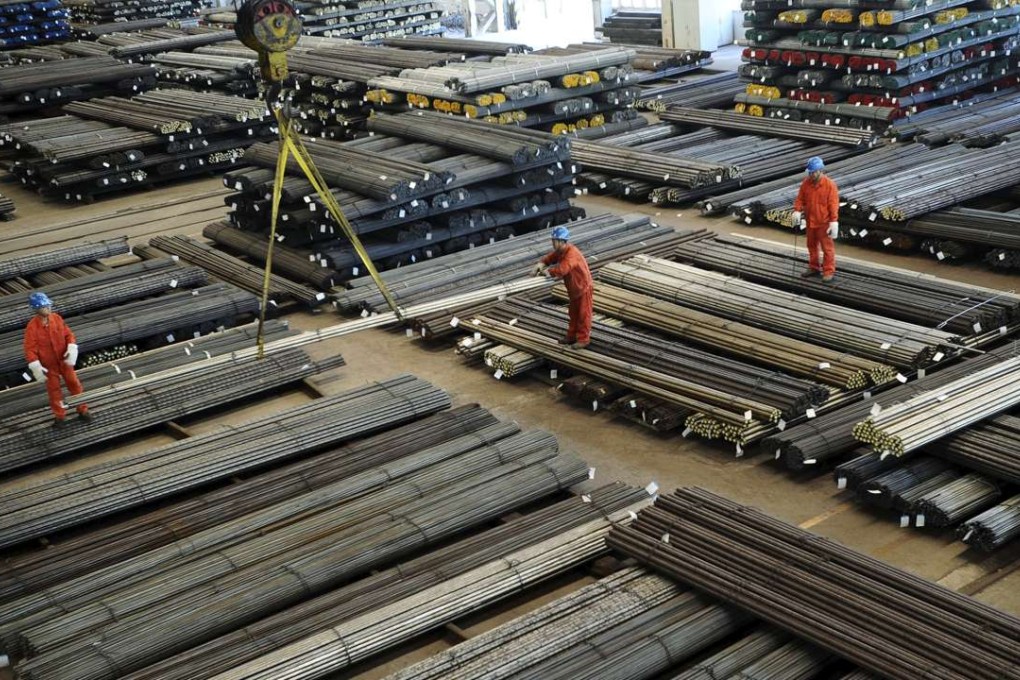 Workers direct a crane lifting newly made steel bars at a factory in Dalian, Liaoning province, China, Economic growth estimates have been in steady decline in China since 2010. Photo: Reuters