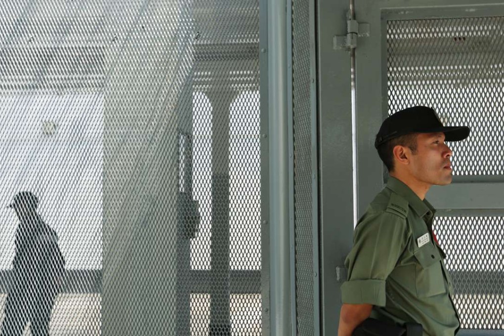 A guard stands watch at Stanley Prison. Photo: Xiaomei Chen