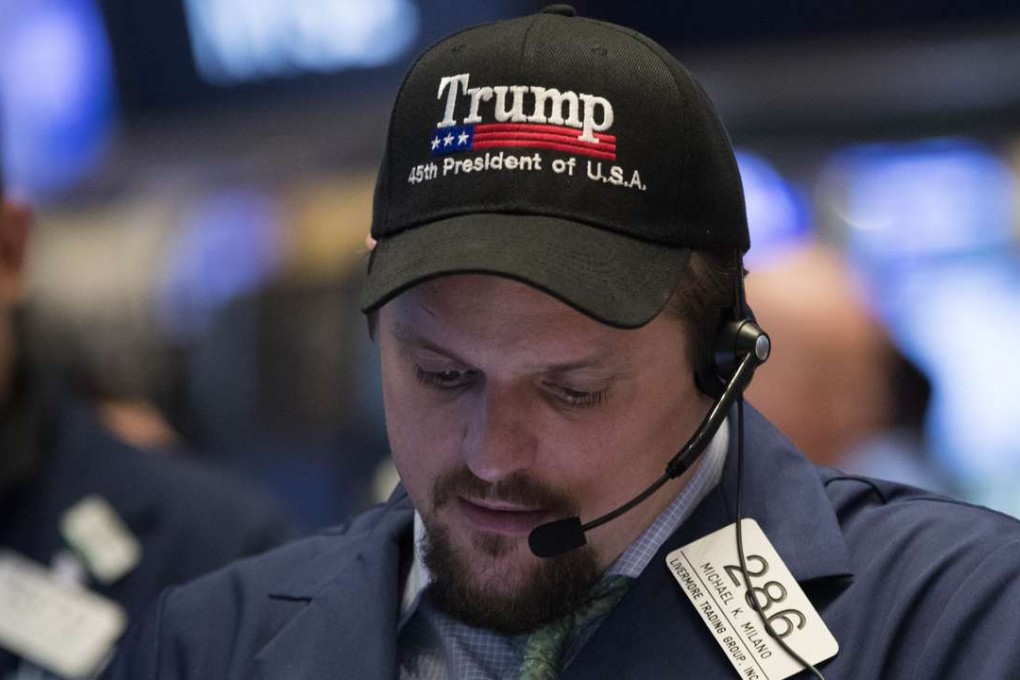 A trader wearing a 'Trump' hat works on the floor of the New York Stock Exchange (NYSE) as equities gained after release of the US jobs report which pointed to the likely increase of US rates by the Fed next week. Photo: AFP