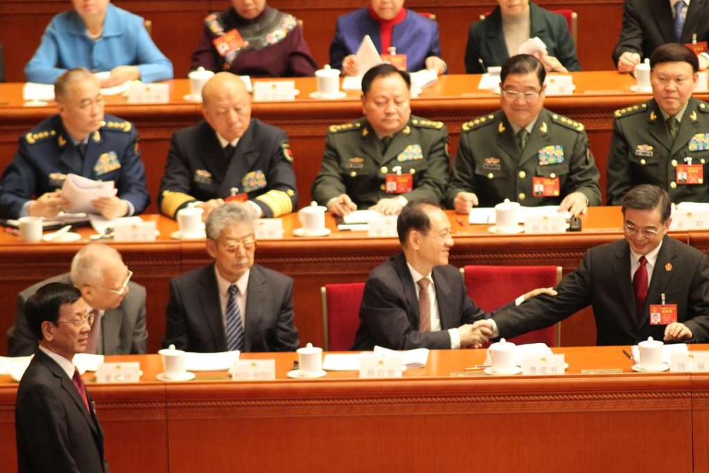 China’s chief prosecutor Cao Jianming (left) walking to the stage to present his annual report to lawmakers and political advisers, after his Supreme Court counterpart Zhou Qiang (first from the right, first row) presented his, in Beijing on Sunday. Photo: Simon Song