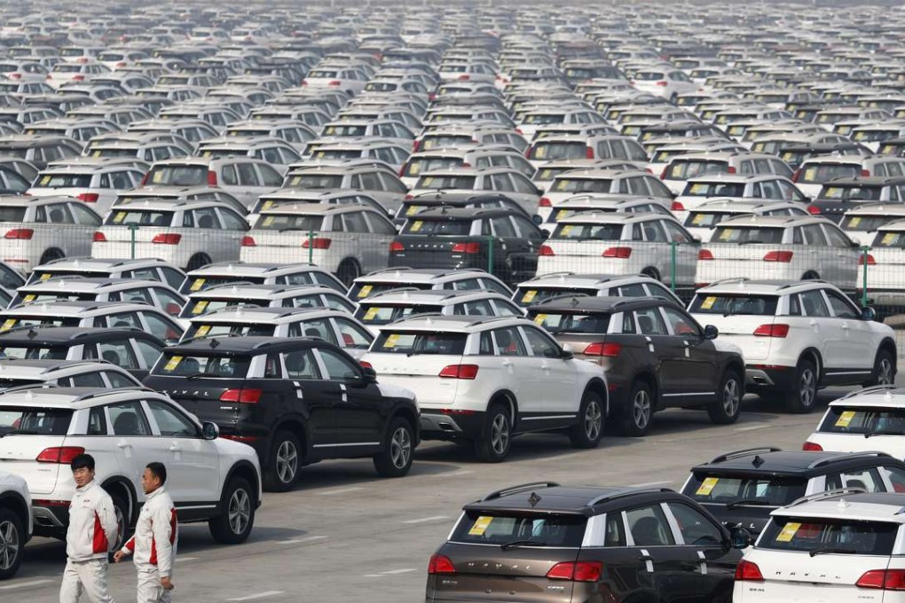 Workers walk past Haval SUV models parked outside the Great Wall Motors assembly plant in Baoding, Hebei province. Output of most industrial products rose compared with the same period last year, statistics bureau chief Ning ­­Ji­zhe said. Photo: AP