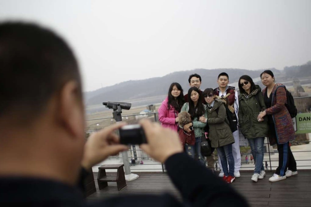 Mainland Chinese tourists could flock to Hong Kong as an easy travel option in the wake a diplomatic row between Beijing and Seoul. Chinese tourists take pictures at the Imjingak Pavilion near the border village of Panmunjom, in Paju, north of Seoul, South Korea. Photo: AP