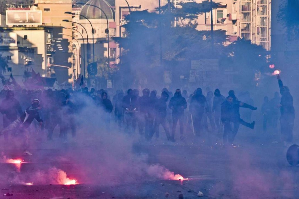 Protesters clash with police during a protest against the visit of Northern League leader Matteo Salvini in Naples on Saturday. Photo: EPA