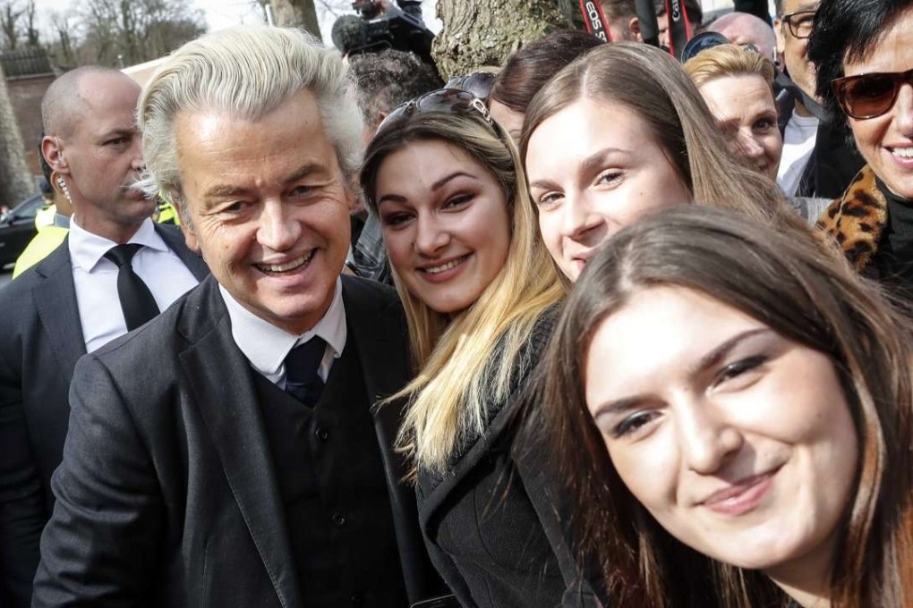 Geert Wilders (left) of the Dutch PVV Party meets with members of the public in Valkenburg, The Netherlands, on Saturday. Photo: EPA