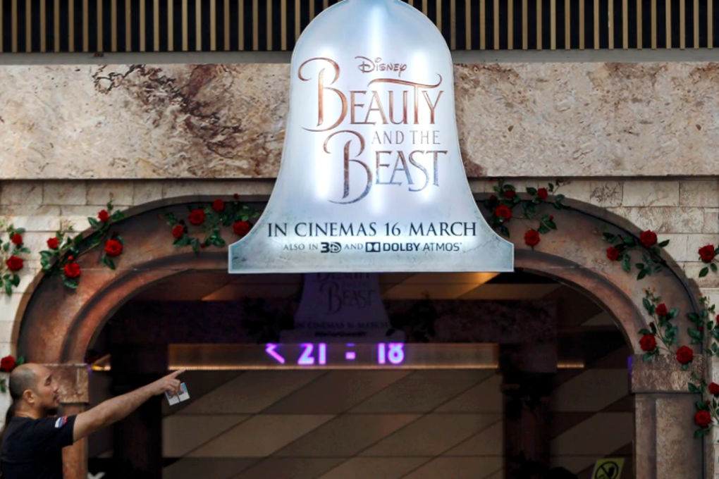 A man walks in front of the a movie advertising board at shopping mall in Kuala Lumpur, Malaysia Tuesday, March 14, 2017. The Malaysian Censorship Board (LPF) today said Disney's new movie, Beauty and the Beast has been approved with minor cut before its initial March 16 release date. Photo: AP