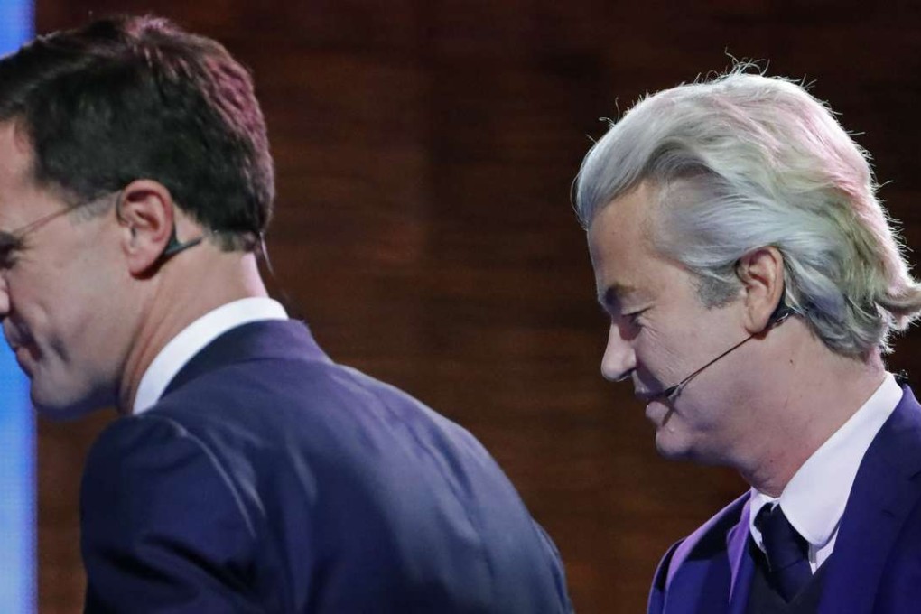 Dutch right-wing populist candidate Geert Wilders (right) and Prime Minister Mark Rutte leave the stage after a televised debate at Erasmus University in Rotterdam, Netherlands, on Monday. Photo: AP
