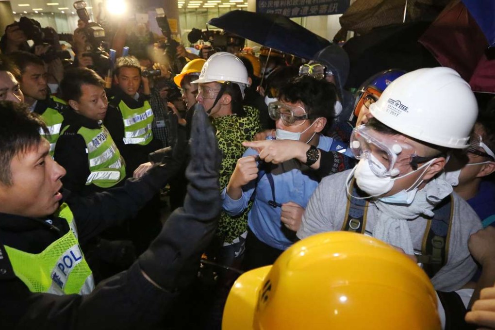 Riot police try to stop pro-independence protesters from breaking into the Legco building in Admiralty. Photo: Felix Wong