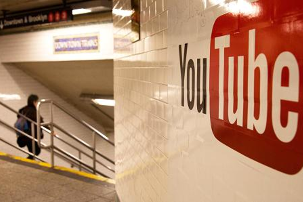 Pedestrians walk past YouTube advertising in the New York subway. Photo: Scott Mlyn/CNBC